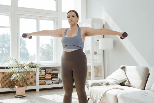 Woman lifting weights to boost metabolism and support weight loss